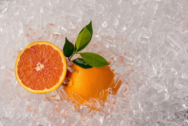 Fresh Orange and Orange Sliced on ice tube background