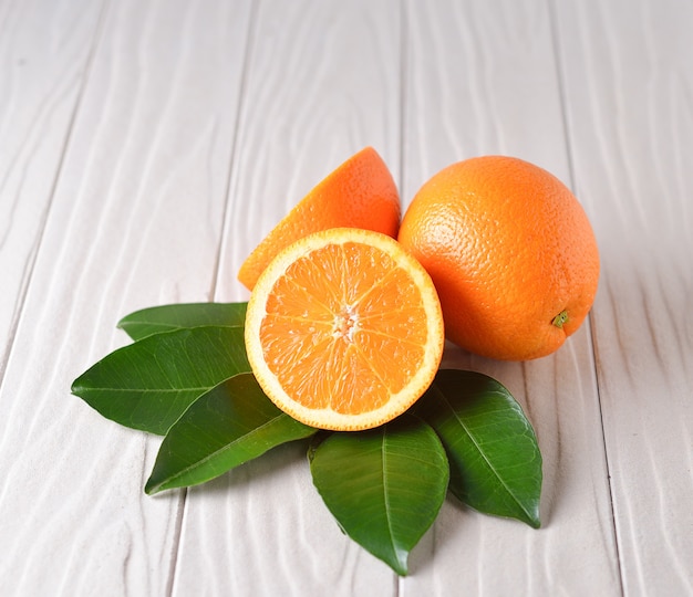 Fresh orange on white wooden table