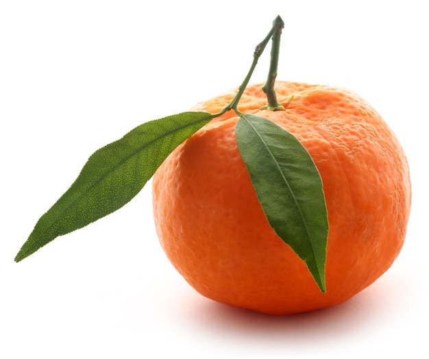 Fresh orange with green leaf over white background