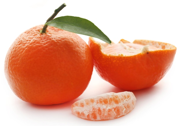 Fresh orange with green leaf over white background