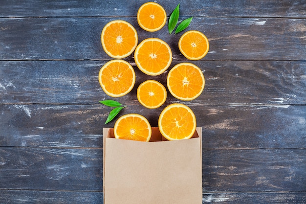 Fresh oranges on dark wooden table