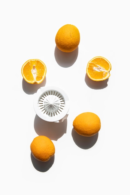 Fresh oranges prepared for juicing in a hand bowl on a white background Top view flat lay