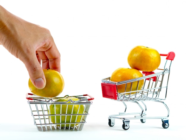 The fresh oranges and shopping cart, basket shopping concept with white background