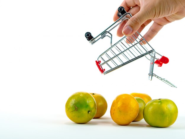 The fresh oranges and shopping cart, basket shopping concept with white background