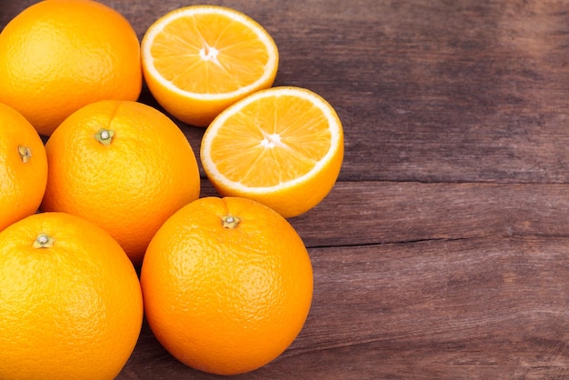 Fresh oranges on wood