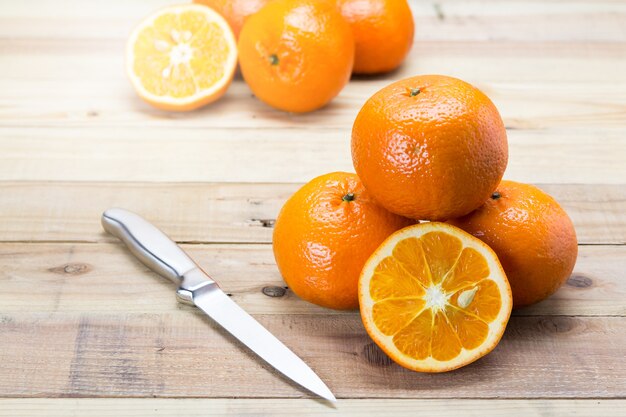 Fresh oranges on wooden background.