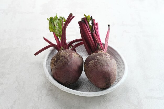 Fresh organic beet beetroot in white plate on a white background Selected focus