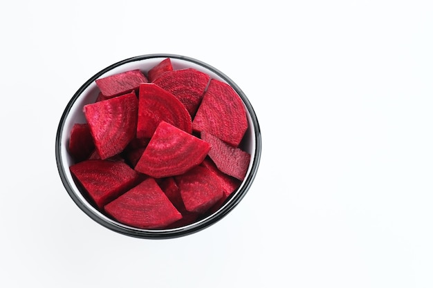 Fresh Organic Beetroot Slices served in a bowl on a white background.