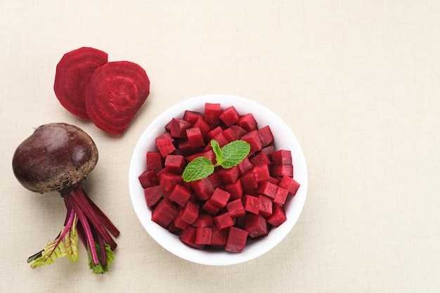 Fresh Organic Beetroot Slices served in a bowl on a wooden background.