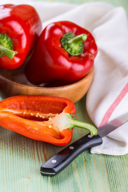 Fresh organic bell peppers on a wooden board