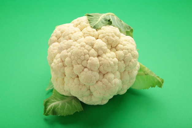 Fresh organic cauliflower on green background Flat lay Top view