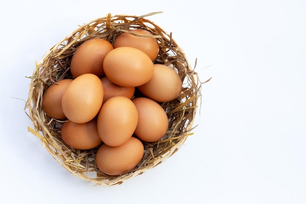 Fresh organic eggs in a straw nest