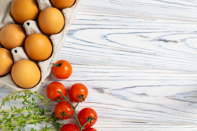 Fresh organic eggs, tomatoes and thyme