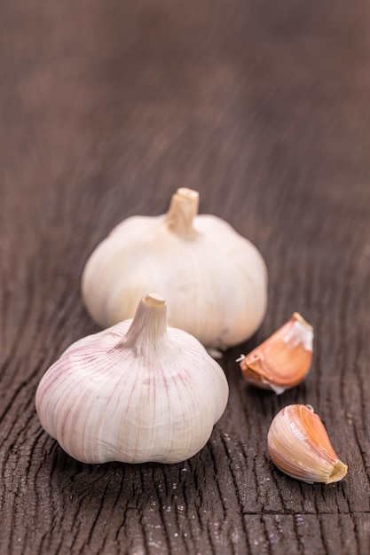 fresh organic garlic on wooden table close up