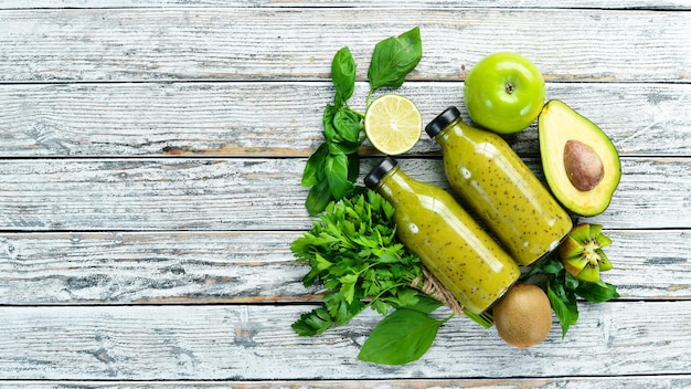 Fresh organic green smoothie on a wooden background Fresh Green Fruits and Vegetables Organic food Rustic style Top view Free space for text