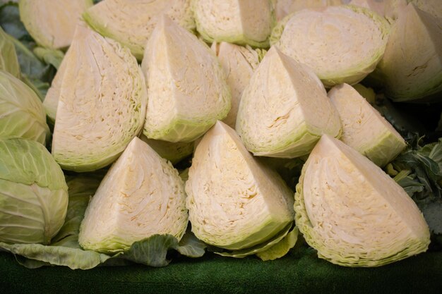 Fresh organic heads of cabbages cut in pieces on the farmers market