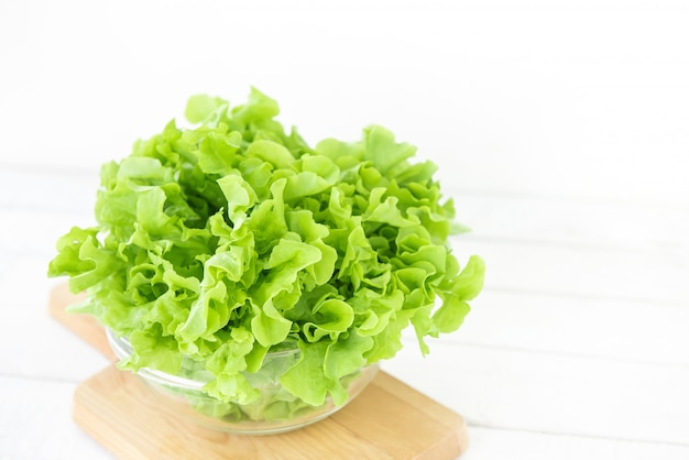 Fresh organic healthy green oak lettuce vegetable in a glass bowl 