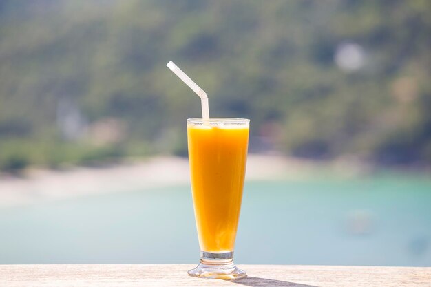 Fresh organic Mango shake in thai restaurant on the beach near sea in island Koh Phangan Thailand Close up