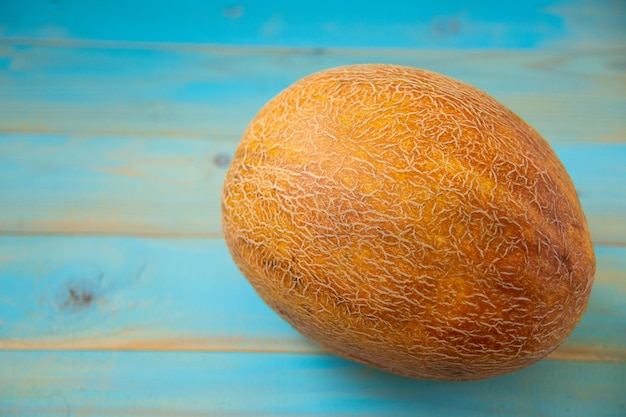 Fresh organic melon on blue  background copy space