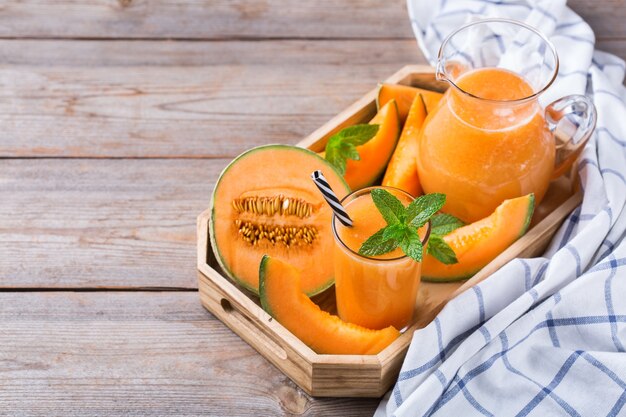 Fresh organic melon cantaloupe smoothie on a kitchen table