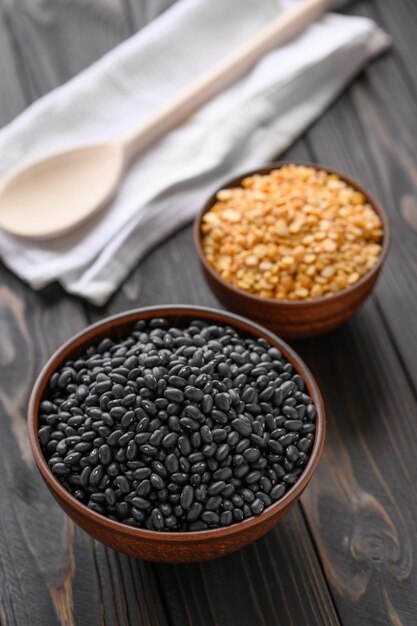 Fresh organic natural beans and peas on wooden rustic black background