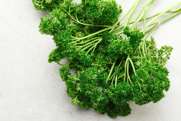 Fresh organic parsley herb on white background Close up and copy space Selected focus