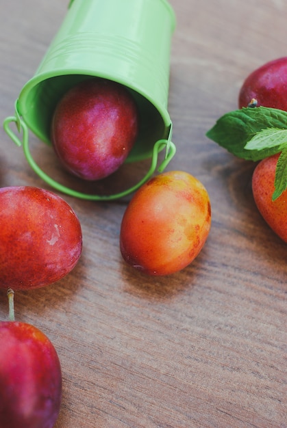 Fresh organic plums in tiny bucket