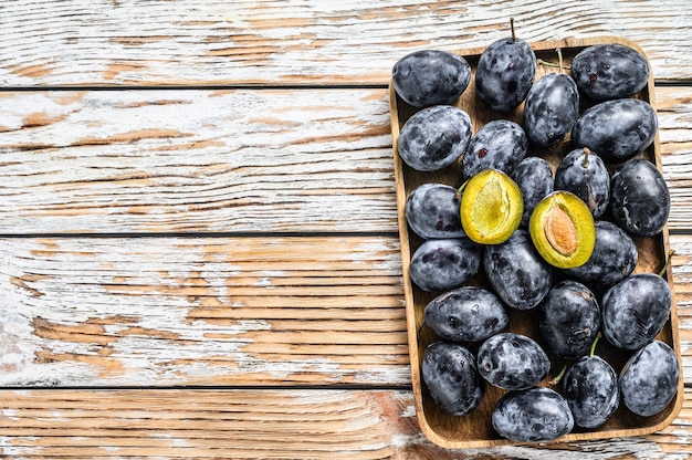 Fresh organic plums on a tray