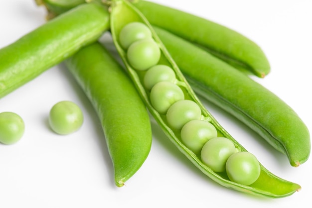 Fresh organic raw green opened peas pod on white background Healthy eating Healthy bean protein above