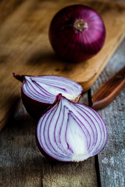 Fresh organic red onions on a wooden background