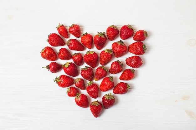 Fresh organic ripe strawberries in a heart shape