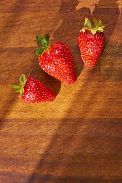 Fresh organic strawberries on a wooden surface