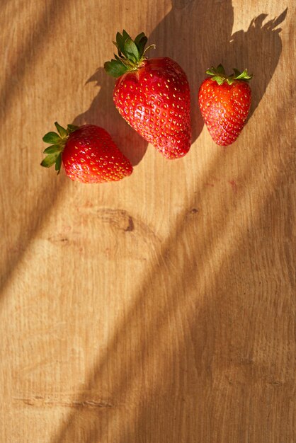 Fresh organic strawberries on a wooden surface