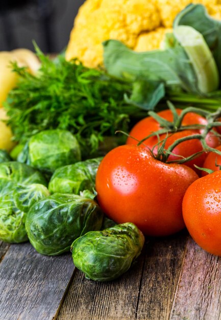 Fresh organic vegetable in season on old farm table.