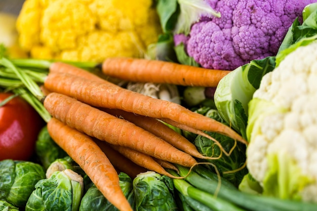 Fresh organic vegetable in season on old farm table.