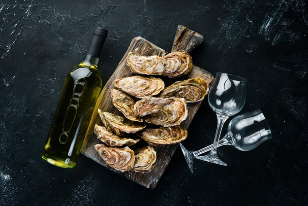 Fresh oysters with ice and white wine Seafood Top view Free copy space