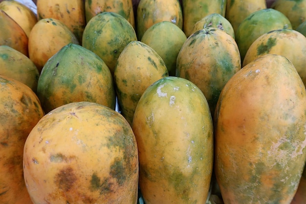 fresh papaya fruits on top view as background