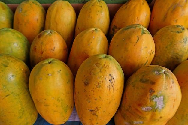 fresh papaya fruits on top view as background