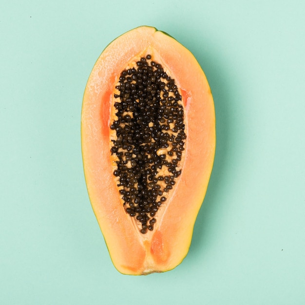 Fresh papaya isolated on mint background