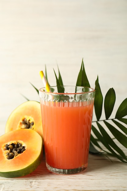 Fresh papaya juice on white wooden table