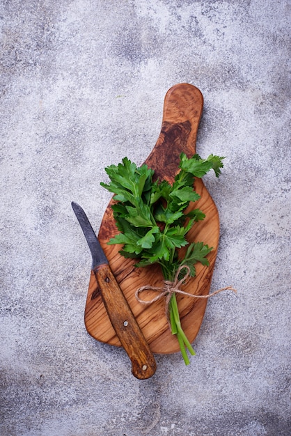 Fresh parsley, knife  and cutting board