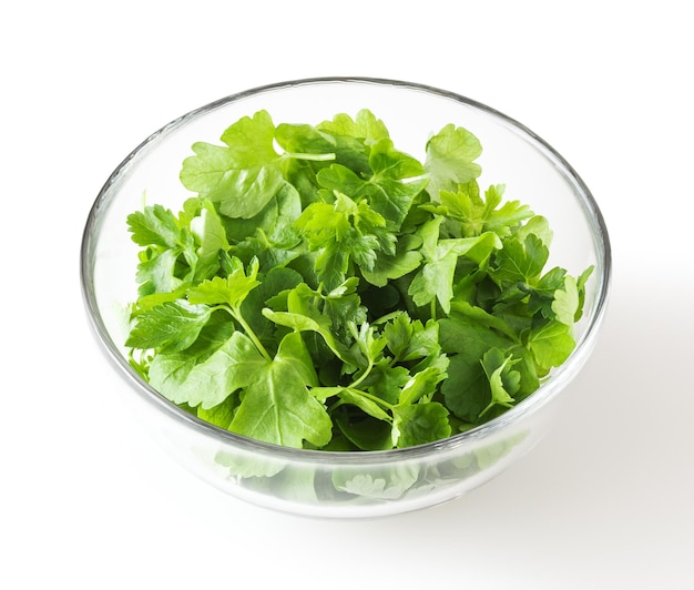 Fresh parsley leaves in glass bowl isolated on white background with clipping path