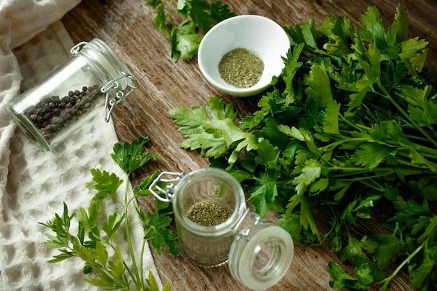 Fresh parsley and spices on a wooden board