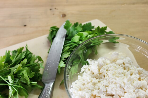 Fresh parsley with knife on a wooden cutting board