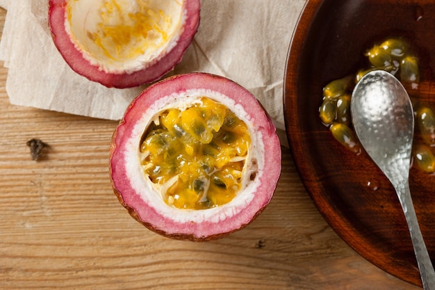 Fresh passion fruit on wooden background. Passion fruit contains many small black seeds covered with the fruit's flesh.