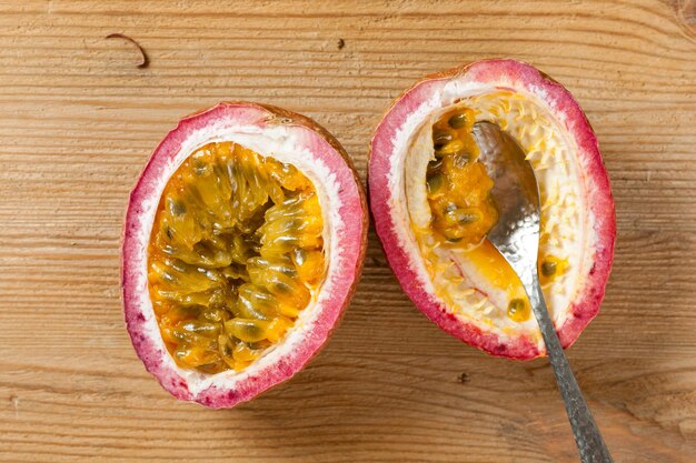 Fresh passion fruit on wooden background. Passion fruit contains many small black seeds covered with the fruit's flesh.