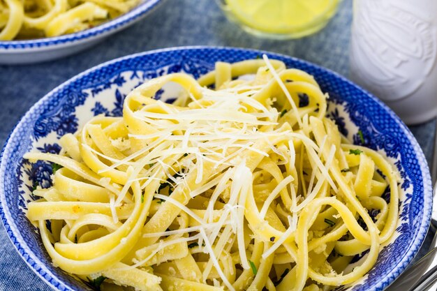 Fresh pasta pangrattato with crispy eggs on the table.