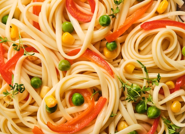 Fresh pasta with green peas bell peppers and corn Macro shooting Closeup Wallpapper with pasta