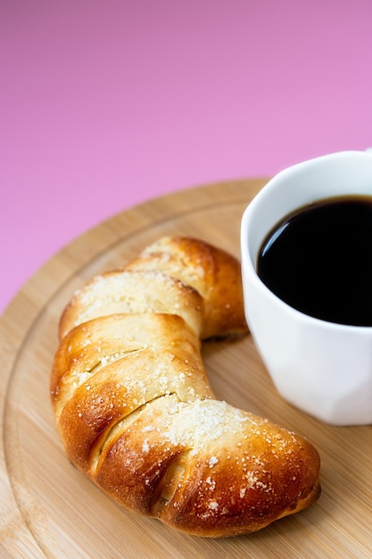 fresh pastries and coffee on pink background top view breakfast concept