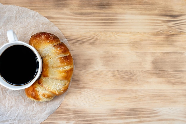 fresh pastries and coffee on wooden background top view breakfast concept